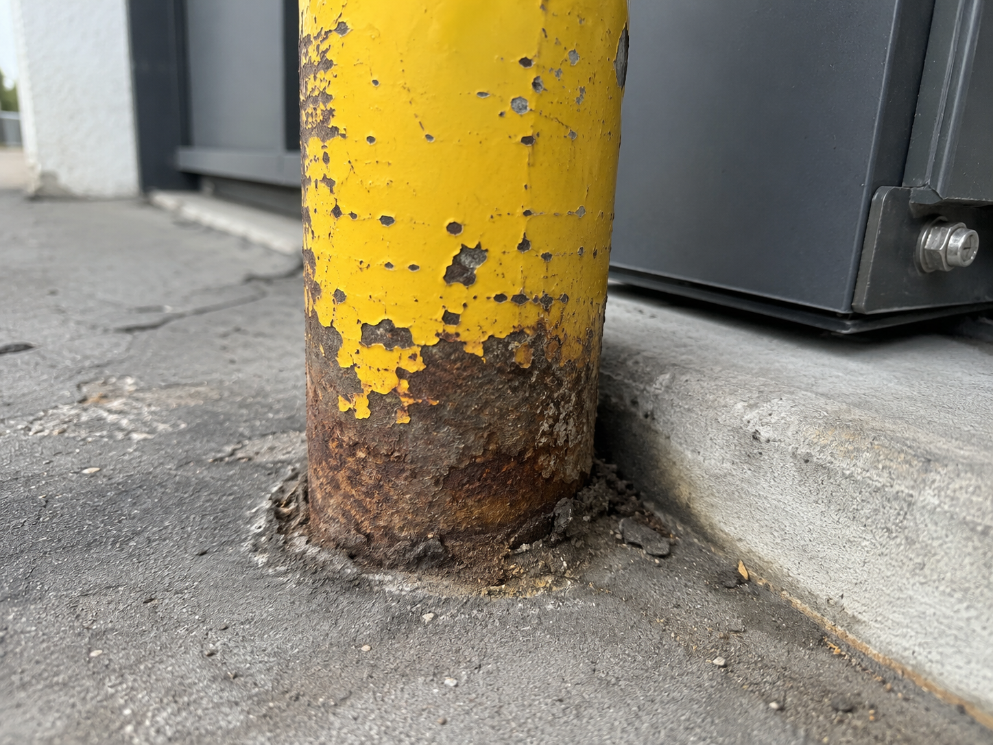 Weathered Yellow Post and Concrete Edge